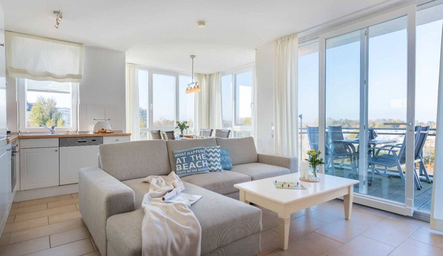 Vacation apartment Strandperle 9 in Großenbrode. Wonderful balcony to relax on. Exclusive wellness oasis with sauna & corner bathtub. Seasonal beach chair included. Practical washing machine available in Großenbrode
